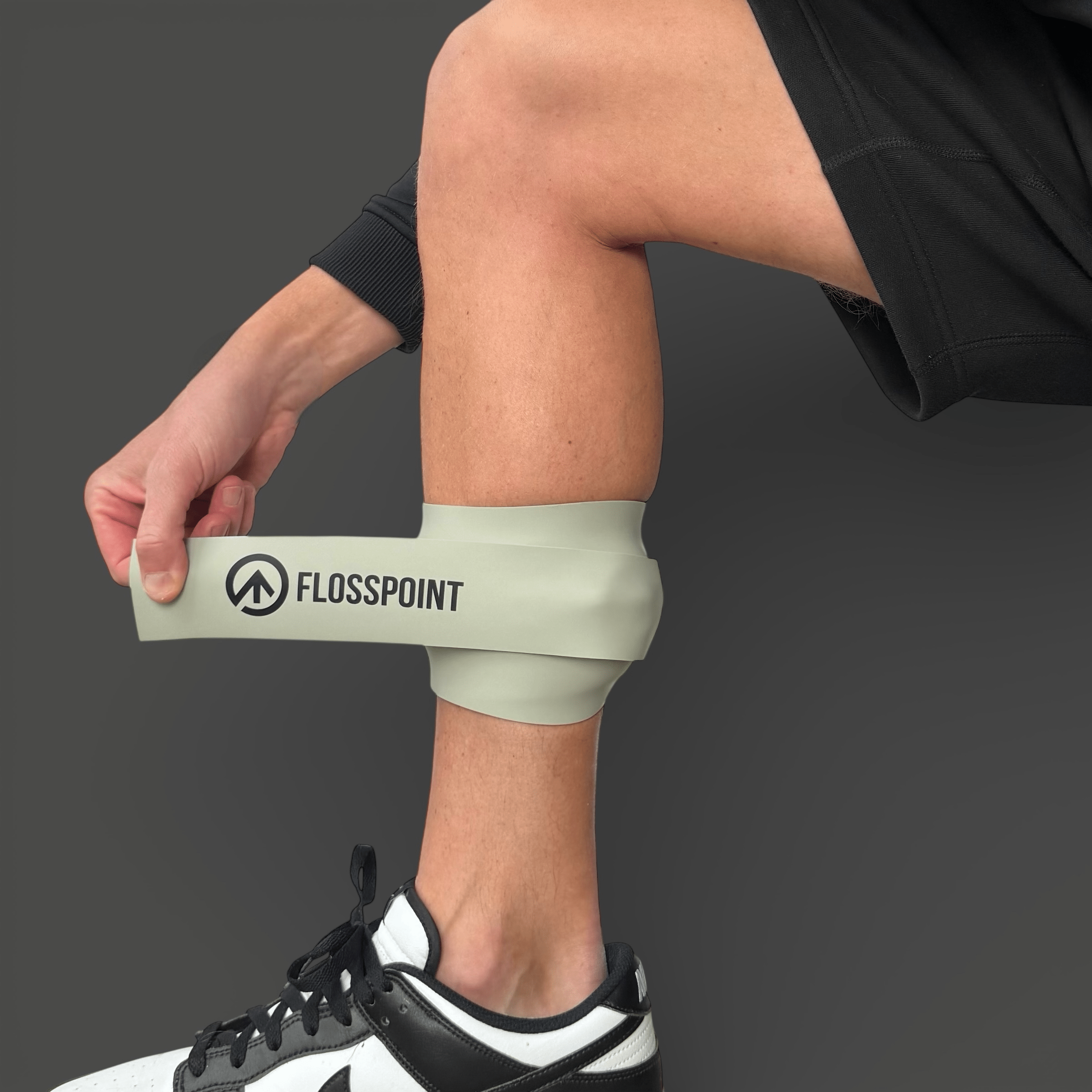 FlossPoint band with ShearPoints applied to calf muscle during running warm-up for tissue restriction treatment