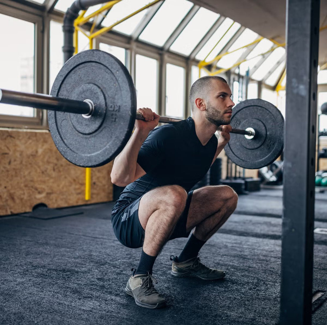 Athlete squat with dorsiflexion restriction during squatting and loaded knee flexion | FlossPoint